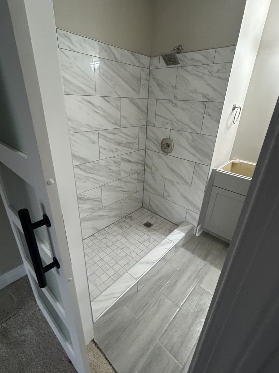 Custom marble tile walk-in shower remodel