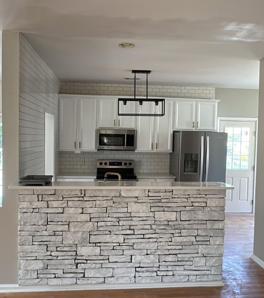 Kitchen remodel with stone island, subway tile, and custom cabinetry